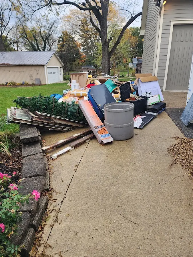 Dumpster being loaded with debris for Roofing Dumpster Rental in Barnesville